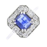 An 18ct gold sapphire and diamond cluster ring. Of square outline, the rectangular-shape sapphire,