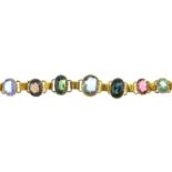 A gem-set bracelet. Designed as a graduated series of oval-shape gemstones, to include garnet,