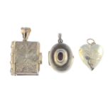 A selection of jewellery. To include a silver scrolling motif book pendant, a heart-shape