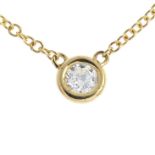 A 9ct gold diamond necklace. The brilliant-cut diamond collet, suspended from an integral belcher-