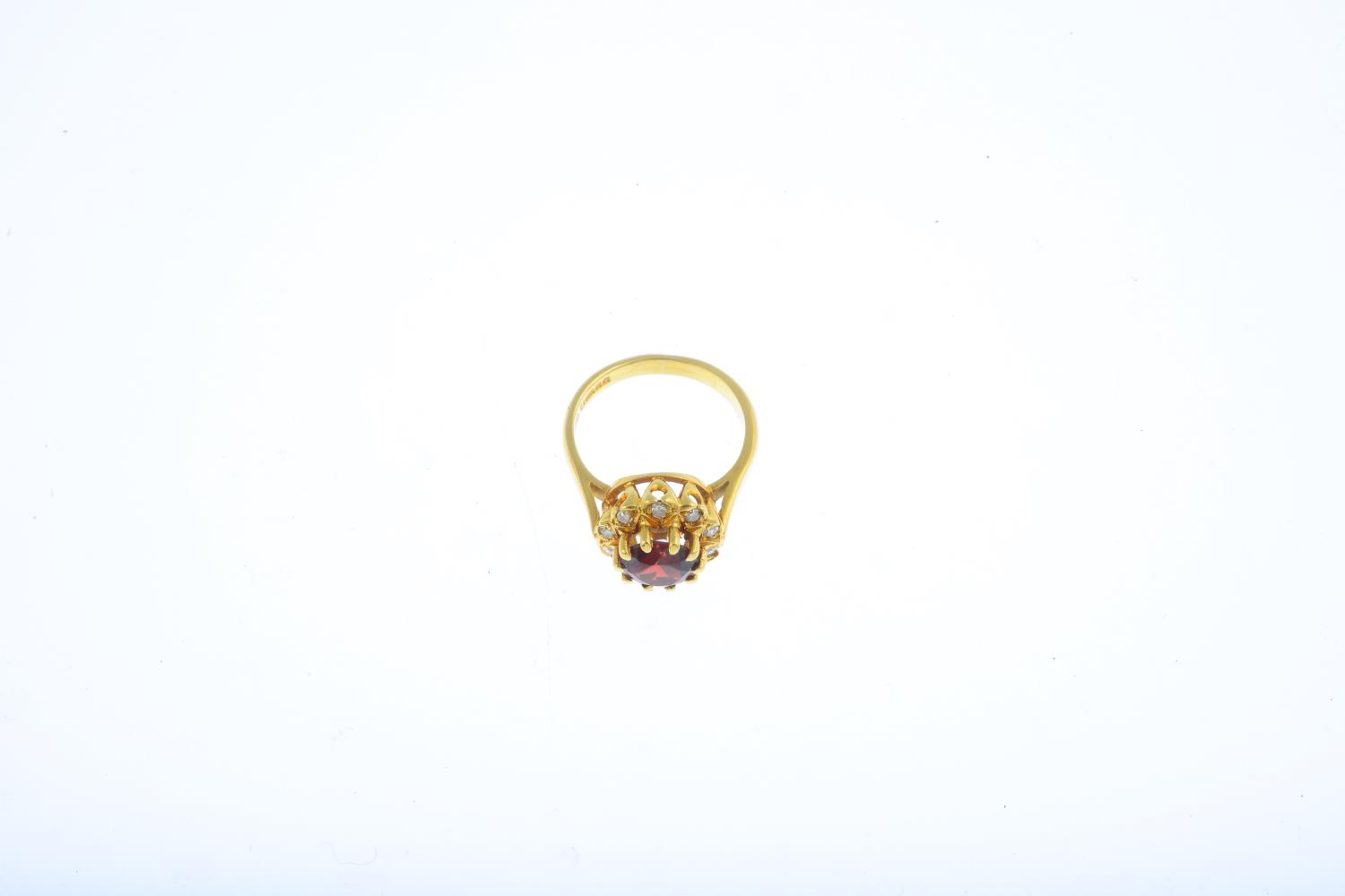 An 18ct gold garnet and diamond cluster ring. The circular-shape garnet, within a single-cut diamond - Image 3 of 3