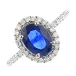 A sapphire and diamond cluster ring. The oval-shape sapphire, with brilliant-cut diamond surround