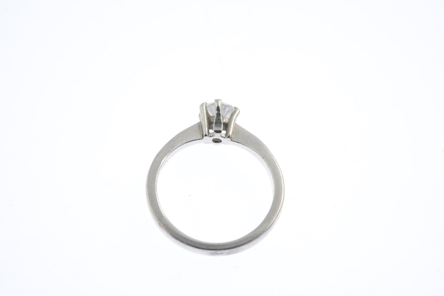 A platinum diamond single-stone ring. The brilliant-cut diamond, with tapered shoulders. Estimated - Image 2 of 3