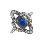 A sapphire and diamond dress ring. Of openwork design, the oval-shape sapphire, with single-cut