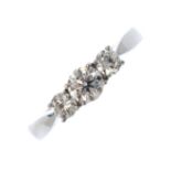 An 18ct gold diamond three-stone ring. The graduated brilliant-cut diamond line, with tapered