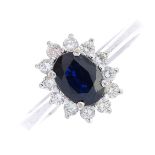 A sapphire and diamond cluster ring. The oval-shape sapphire, with brilliant-cut diamond surround