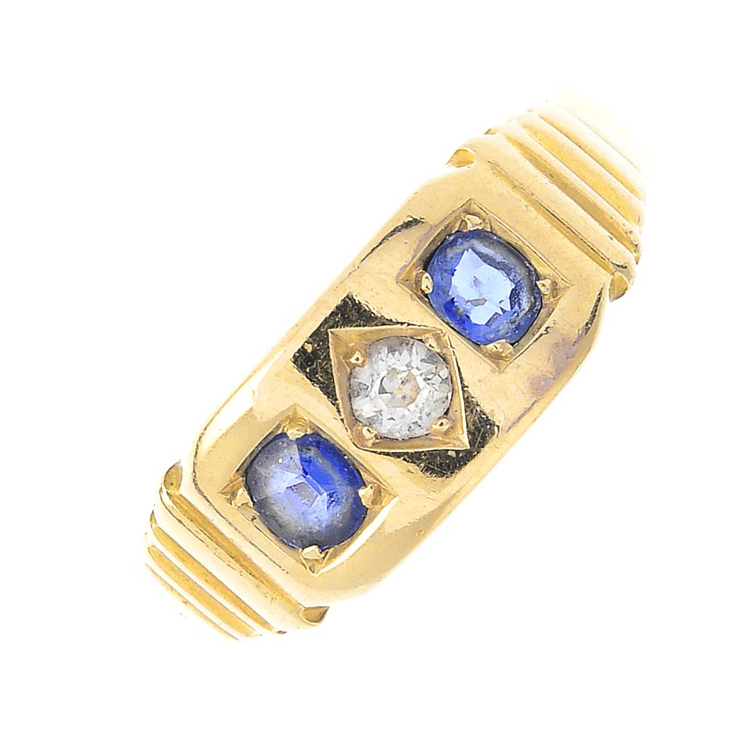 A sapphire and diamond three-stone ring. Designed as an old-cut diamond, with oval-shape sapphire