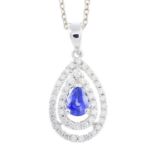 A sapphire and diamond cluster pendant. The pear-shape sapphire, within a brilliant-cut diamond