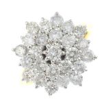 An 18ct gold diamond cluster ring. The brilliant-cut diamond, with similarly-cut diamond