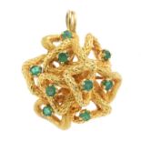 An emerald pendant and a 9ct gold chain. Of abstract design, the circular-shape emerald scattered