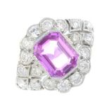 A sapphire and diamond cluster ring. The rectangular-shape pink sapphire, with circular-cut