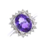 An amethyst and diamond cluster ring. The oval-shape amethyst, with brilliant-cut diamond undulating