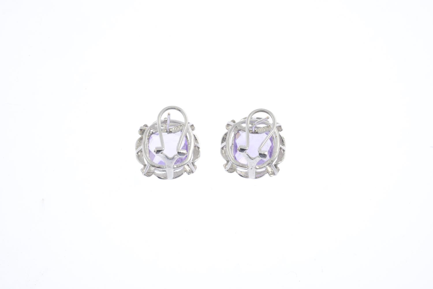 A pair of amethyst earrings. Each designed as a cushion-shape amethyst, within a grooved openwork - Image 2 of 2