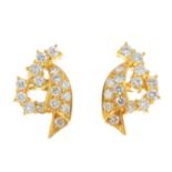 A pair of diamond earrings. Each designed as a pave-set diamond scrolling panel, with brilliant-