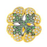 A tsavorite garnet and diamond clover ring. Of bi-colour design, the pave-set tsavorite garnet and