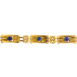 A sapphire bracelet. Designed as a series of circular sapphire collets, at intervals to the