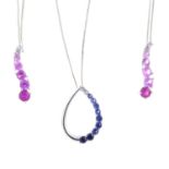 Three sapphire pendants. To include a circular-shape blue and colourless sapphire pendant with