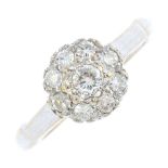 An 18ct gold diamond cluster ring. The brilliant-cut diamond, with similarly-cut diamond surround