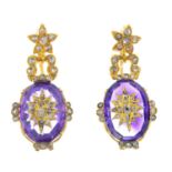 A pair of amethyst and diamond earrings. Each designed as an old and rose-cut diamond star, inset to