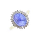 An 18ct gold sapphire and diamond cluster ring. The oval sapphire cabochon, within a single-cut