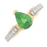 An 18ct gold tsavorite garnet and diamond ring. The pear-shape tsavorite garnet, with brilliant-