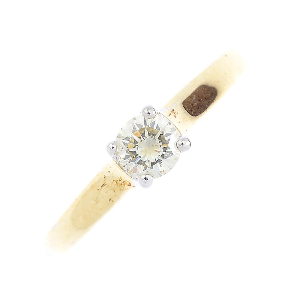 A 9ct gold diamond single-stone ring. The brilliant-cut diamond, with tapered shoulders. Estimated
