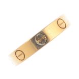 CARTIER - an 18ct gold 'Love' ring. Designed as a series of screw head motifs. Swiss convention