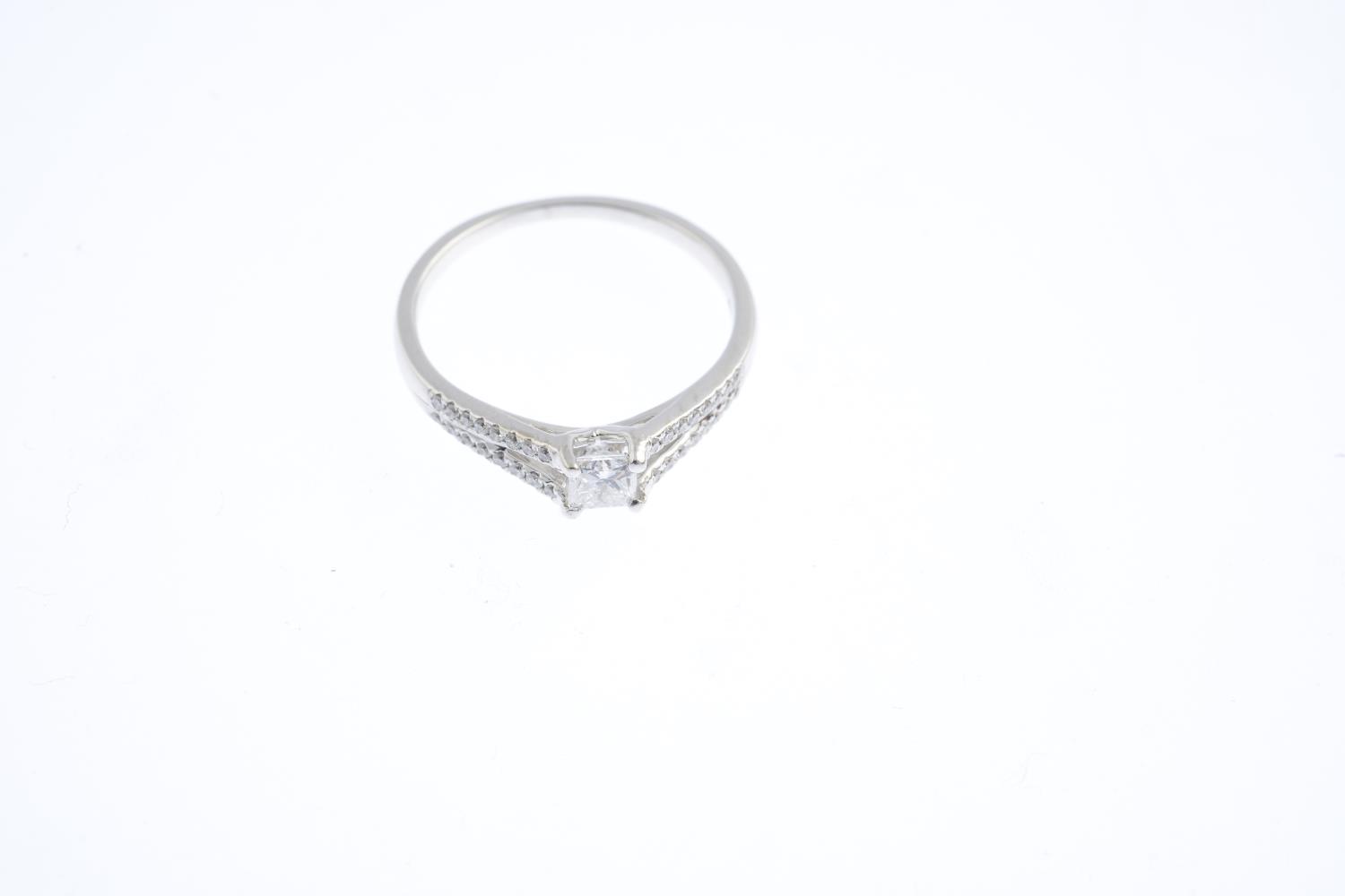 An 18ct gold diamond ring. The square-shape diamond, with brilliant-cut diamond chevron shoulders. - Image 3 of 3