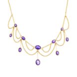 An Edwardian 9ct gold amethyst necklace. Designed as a graduated oval-shape amethyst fringe and