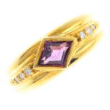 A garnet and diamond dress ring. The kite-shape garnet collet, with brilliant-cut diamond line and