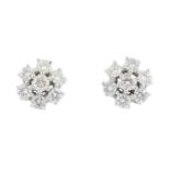 A pair of 9ct gold diamond cluster earrings. Each designed as a brilliant-cut diamond, within a