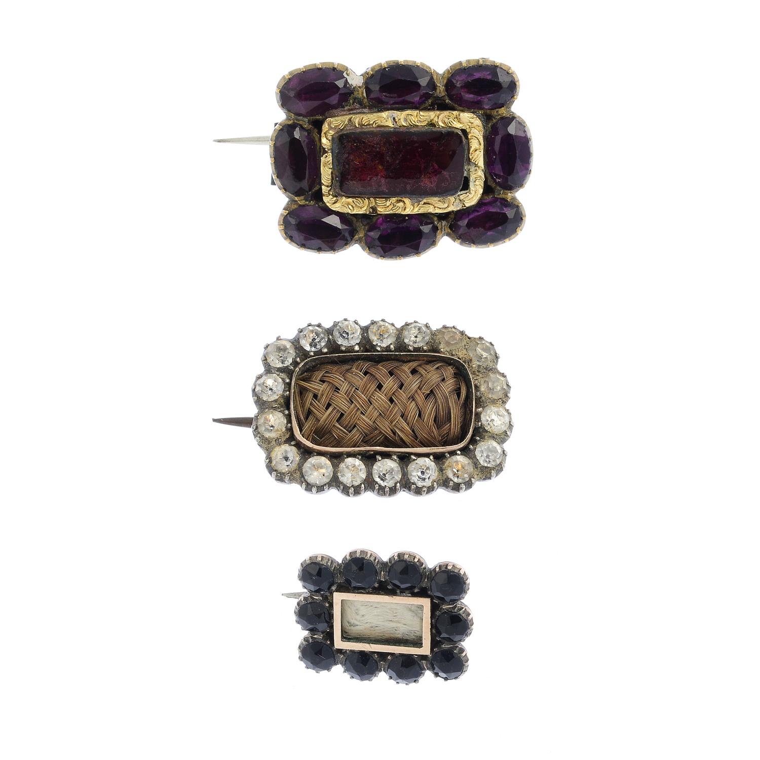 Seven items of jewellery. To include three early 19th century memorial brooches, a gem-set butterfly