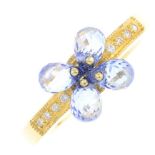 An 18ct gold sapphire and diamond dress ring. Designed as a briolette-cut sapphire quatrefoil,