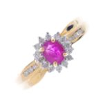 A 9ct gold ruby and diamond ring. The oval-shape ruby and brilliant-cut diamond cluster, with