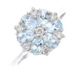 An 18ct gold aquamarine and diamond cluster ring. Designed as an oval-shape aquamarine and