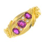 An Edwardian 18ct gold ruby and diamond ring. The graduated oval-shape ruby line, with old-cut