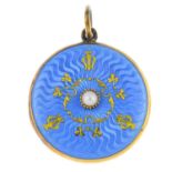 An early 20th century gold, enamel and split pearl locket. Of circular outline, the blue enamel