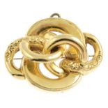 A brooch. Designed as a series of polished and textured interlinking crescents. Length 4.8cms.