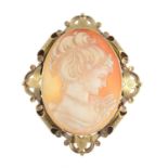 A 9ct gold shell cameo brooch. The oval shell cameo, carved to depict a woman in profile, with