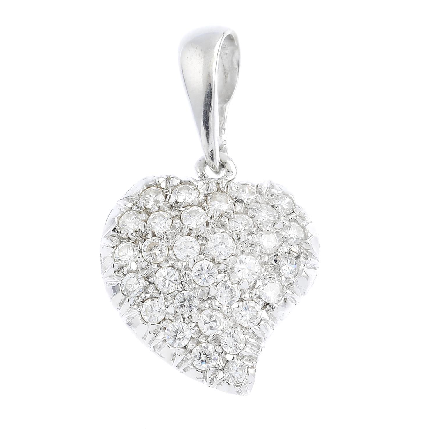 An 18ct gold diamond pendant. The pave-set diamond stylised heart, suspended from a tapered