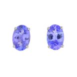 A pair of oval-shape tanzanite single-stone stud earrings.