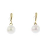 A pair of cultured pearl earrings.