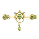 An Art Nouveau gold peridot and split pearl brooch.