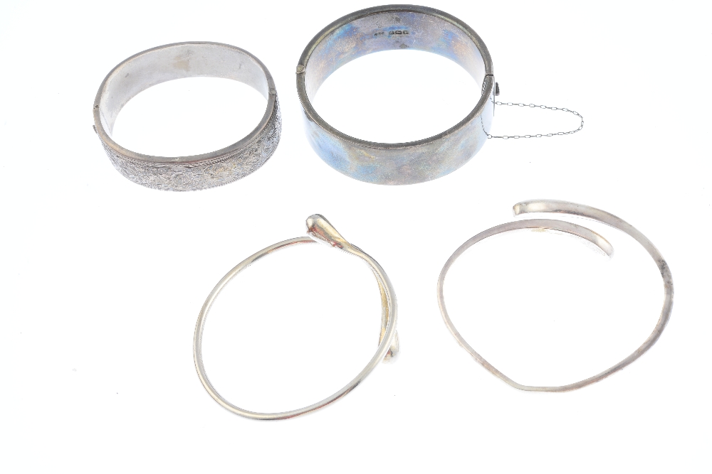 Four bangles. To include an early 20th century silver foliate engraved bangle, a monogram engraved - Image 2 of 3