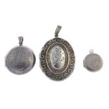 Thirty-nine silver and white metal lockets. To include a silver locket of oval outline with embossed