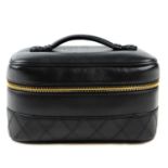 CHANEL - a rectangular leather cosmetics case. Crafted from smooth black lambskin leather, featuring