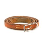 HERMÈS - a leather wraparound Api bracelet. Designed as a tan leather strap with silver-tone