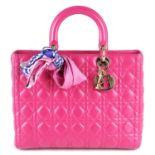 CHRISTIAN DIOR - a fuchsia pink leather Cannage Lady Dior GM handbag.