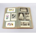 An early 20th century postcard album,