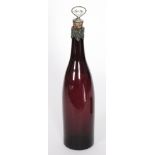 A 19th Century glass spirit decanter of bottle form in amethyst with white metal mounts with